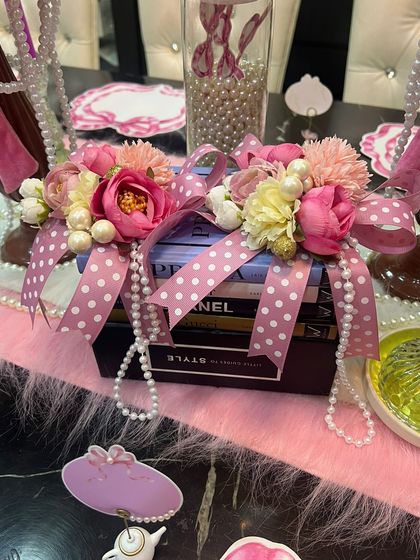 Another element from the coquette theme, where I used books as a decorative base. They are adorned with flowers, pearls, and polka-dot ribbons to tie the entire vintage-inspired look together.