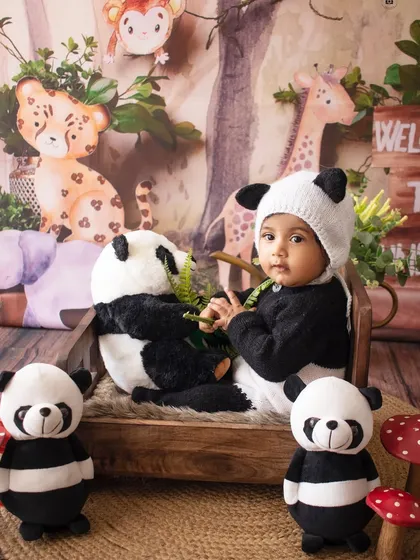 A full view of the jungle setup, with our little panda surrounded by his stuffed animal friends.
