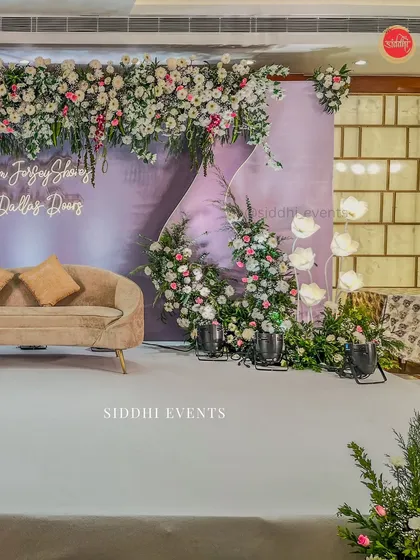 Another perspective of the engagement stage, showcasing the depth of the floral arrangements and the unique paper lotus floor lamps that add a soft, artistic light.
