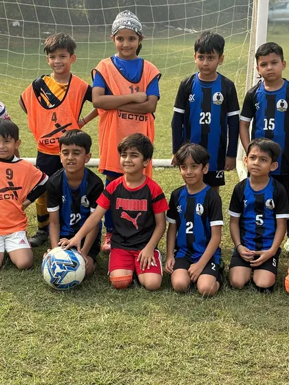 The full U8 squad posing for a team photo before their friendly match against Panthers Football Academy.