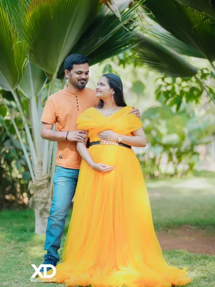 A happy couple's portrait in a garden, their smiles reflecting the joy of this special time.