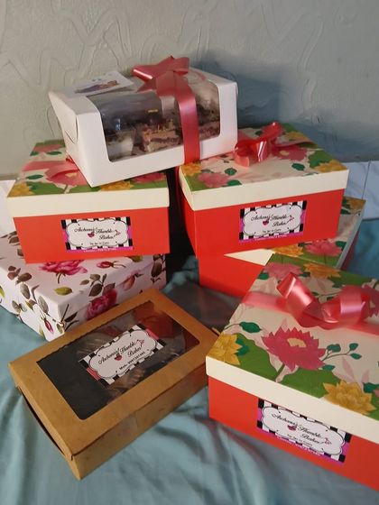 A stack of gift boxes ready for Rakhi deliveries. I use a variety of beautiful boxes, from simple craft paper to vibrant floral prints, to make sure your gift looks as good as it tastes.