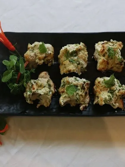A platter of our Murgh Pudina Kalimiri Kabab, beautifully arranged and ready to be served. The combination of mint, pepper, and chili makes for an unforgettable starter.