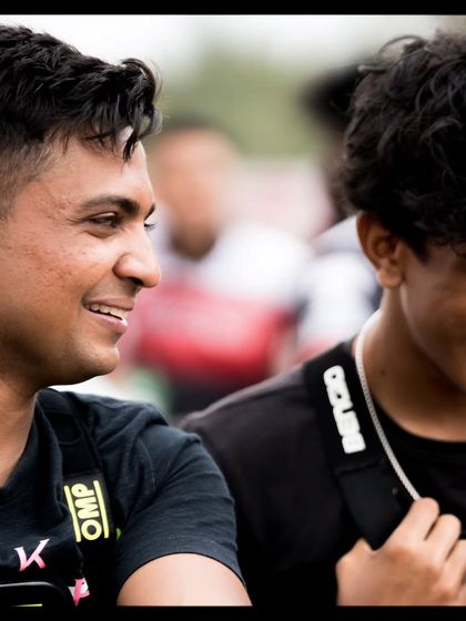 Two drivers sharing a moment of sportsmanship and friendship.