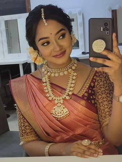 A behind-the-scenes selfie from the actress, giving a closer look at her makeup, jewelry, and the intricate blouse I designed.