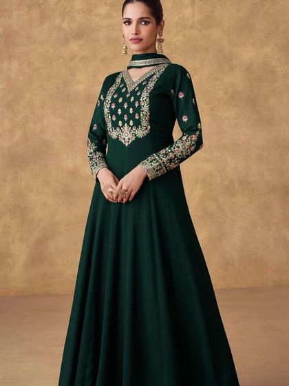 A dark green Anarkali gown that exudes grace. I designed this with heavy thread and sequin work on the neckline and sleeves, using Chinon silk for a beautiful drape.