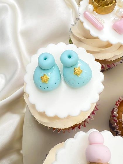 Tiny blue baby booties with little gold stars. Every topper is made with love and attention to detail for your baby shower.