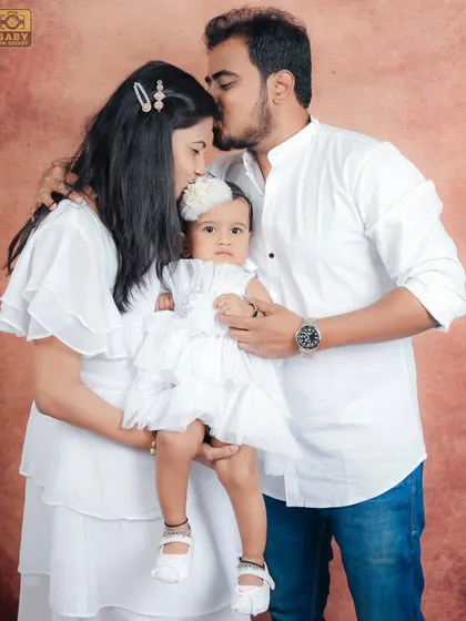 Another loving family portrait, capturing the protective and caring embrace of the parents.