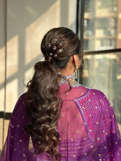 A close-up of the crystal-adorned ponytail. This is a great way to elevate a simple ponytail into a party-ready hairstyle.