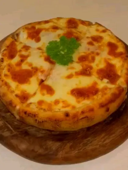 This cheesy, wood-fired pizza is perfect for sharing. The slightly charred crust and bubbly cheese make it an irresistible choice from our savory menu.