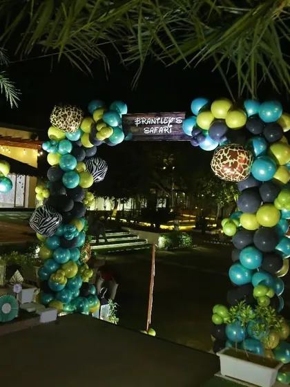 The balloon arch entrance for "Brantley's Safari." The arch is made of green, black, and animal-print balloons, setting the stage for the adventure inside.