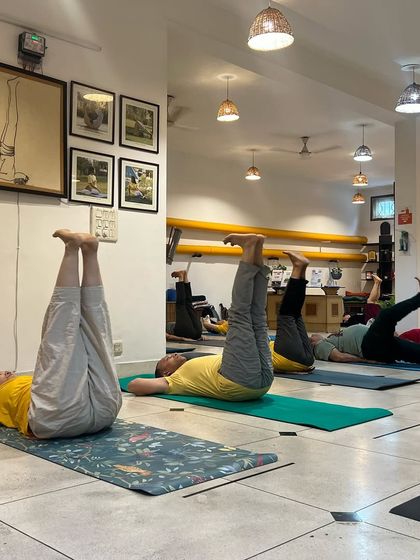 TTC graduates practice leg raises, a core strengthening exercise in the Sivananda sequence. The advanced course builds upon the foundational practices learned in the initial training.