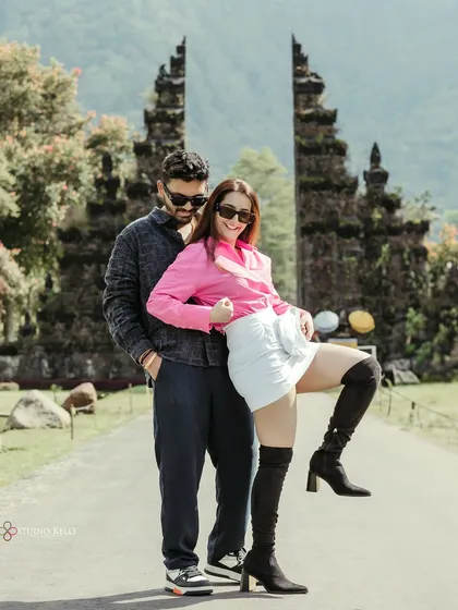 A fun and playful pose in front of Bali's Handara Gate. This shot shows the couple's fun-loving personality and adds a touch of 'desi masti' to their destination shoot.