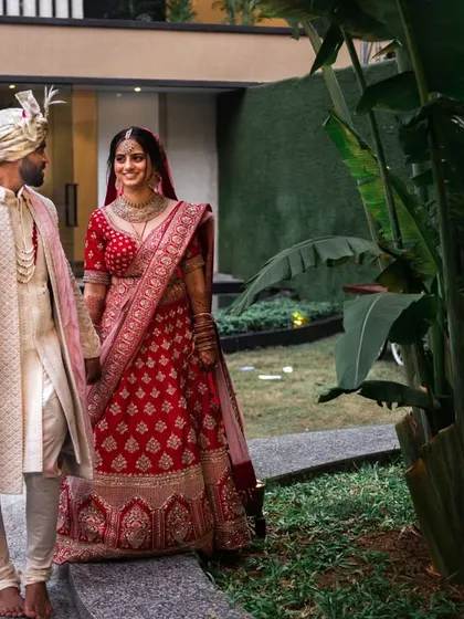 A sweet, candid moment as the couple walks hand-in-hand, sharing a smile. These are the unposed moments that tell a real story.