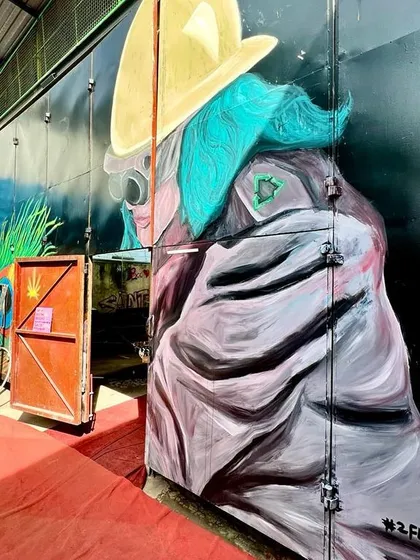 A colorful mural by 2FlatBrush on one of our large container doors, showcasing how art is integrated into every corner of our architecture.
