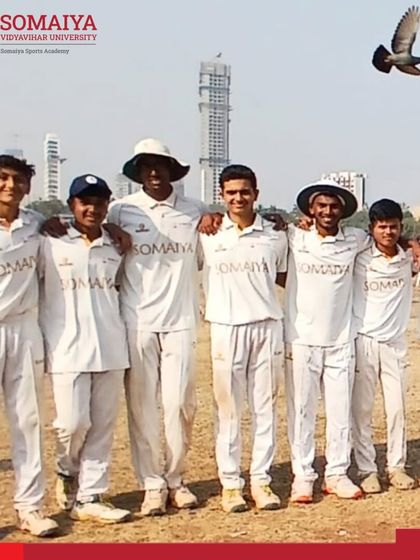 A slightly different angle of the victorious junior college team, with a pigeon photobombing their celebration, adding a unique touch to the memory.