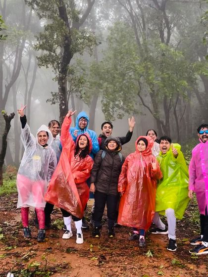 The season's first batch for the Bandaje trek, enjoying the misty forest trail in their colorful raincoats.