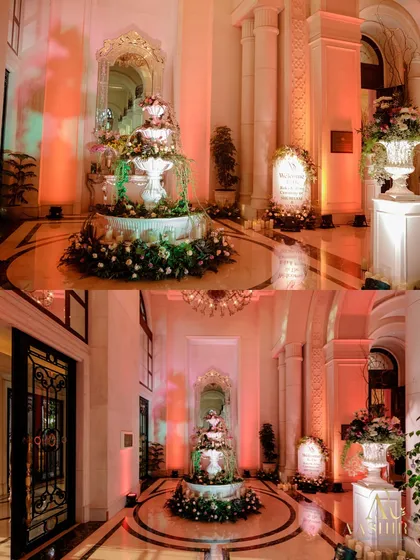This collage shows the floral-dressed fountain from multiple angles, highlighting its role as a grand and romantic welcome feature in the venue's hallway.