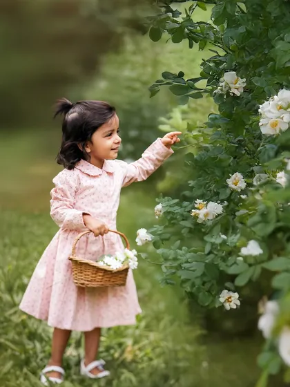 Discovering the beauty of nature. I love watching children explore during our outdoor shoots. This moment of a little girl reaching out to touch a flower is so simple and pure.