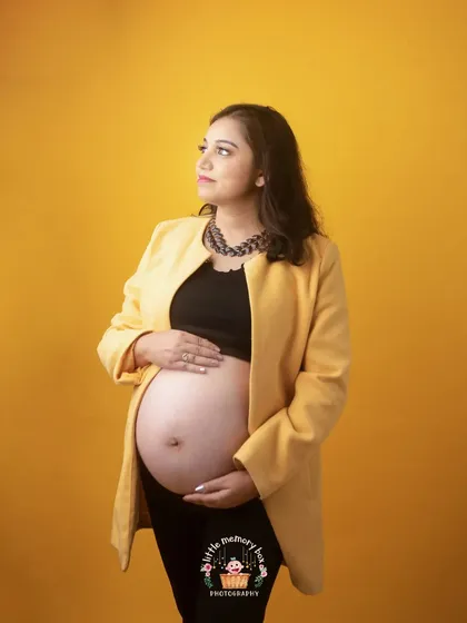 This shot captures a thoughtful expression, looking towards the future. The combination of the yellow jacket and black top is both bold and stylish.