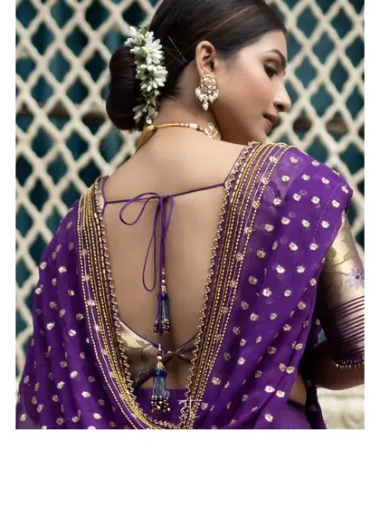 The back of the violet Paithani blouse, featuring an elegant tie-up with tassels and intricate embroidery along the border of the dupatta.