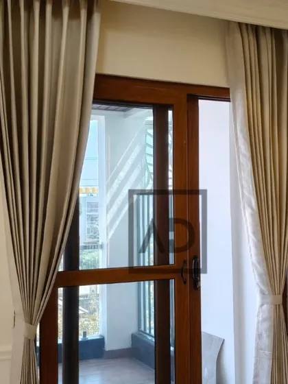 For this balcony door, I used elegant tie-backs to keep the curtains neatly drawn during the day. This allows for easy access and maximum natural light while still adding a touch of decorative framing to the doorway.