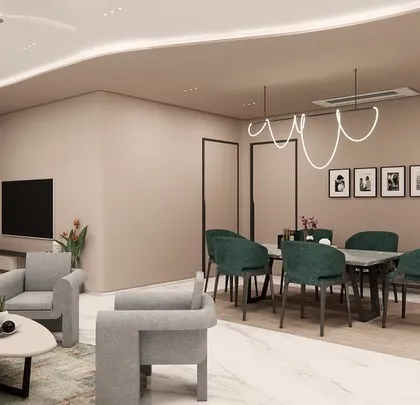 An open-plan living and dining concept for SVASA 2A, where a cohesive beige color scheme unifies the space. A bold green sofa and matching dining chairs add a touch of vibrant energy, while a flowing ceiling detail with cove lighting connects the two zones.