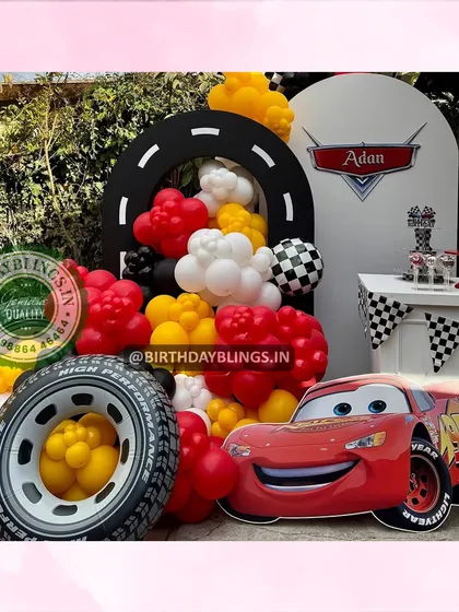 A close-up of the Lightning McQueen party, focusing on the character cutout and the dessert table.