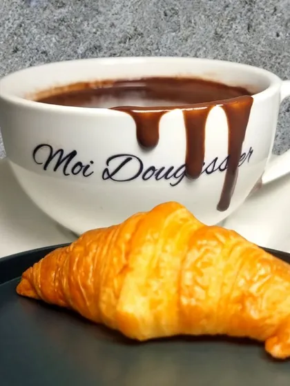 The ultimate comfort pairing. My signature thick, velvety hot chocolate served with a classic, buttery croissant is the perfect indulgence for a cozy afternoon or a rainy day.
