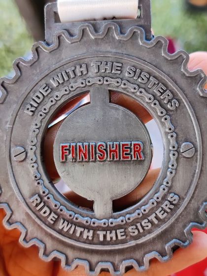 A finisher medal from a "Ride with the Sisters" event. I'm always challenging myself to try new things, and I encourage you to do the same. It's all about finding new ways to move and experience what your body is capable of.