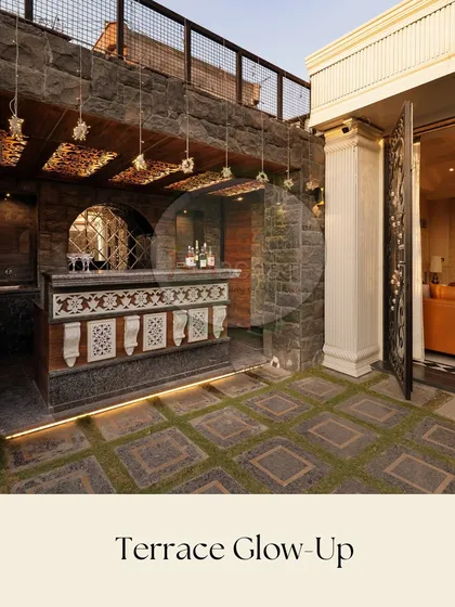 We transformed this once-empty rooftop into a sophisticated entertainment zone. The centerpiece is a custom-designed bar with intricate jaali work, set against rugged stone walls and illuminated by subtle, warm lighting. The flooring combines non-slip granite with artificial grass for a unique texture.