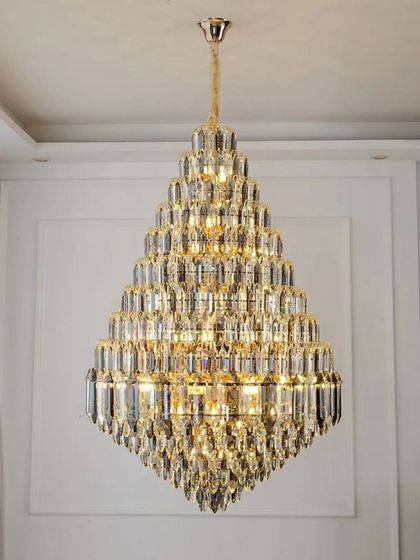 A diamond-shaped crystal chandelier designed for double-height spaces. The high-quality K9 crystals are arranged to maximize brilliance, creating a luxurious and modern focal point.
