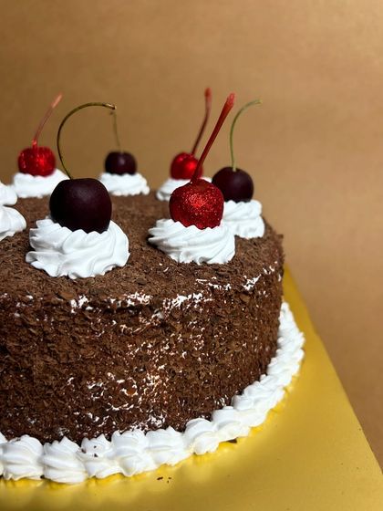A close-up of my Memory Lane Black Forest cake. The contrast between the dark chocolate shavings, white whipped cream, and bright red cherries is just beautiful.