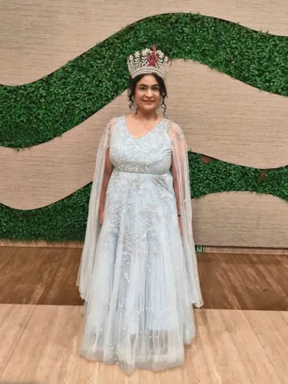 Our happy client, a pageant winner, looking stunning in our powder blue gown with a cape.