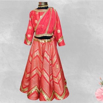 A classic red and gold brocade lehenga with a pre-draped dupatta. This is a timeless, traditional look that is always in style for festive occasions.