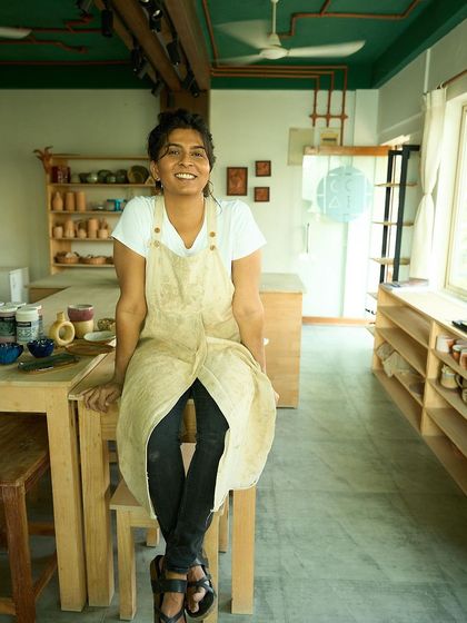 A photo of me sitting at our main work table. After teaching over 100 students, the community we've built is what makes me swell with happiness and pride.