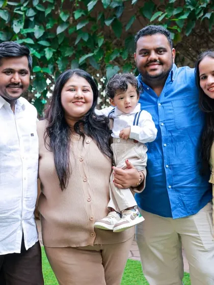 A happy group photo from an outdoor family shoot. The natural greenery provides a fresh and vibrant background for capturing memories with loved ones.
