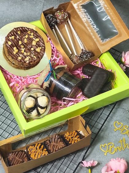 A closer look at one of my larger Rakhi hampers, featuring a mini cake, cake pops, a jar cake, brownies, and other assorted treats.