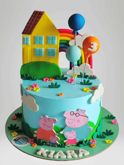 Another fun Peppa Pig cake, this time featuring their iconic yellow house and balloons. The vibrant colors and playful scene make it a hit with young children.