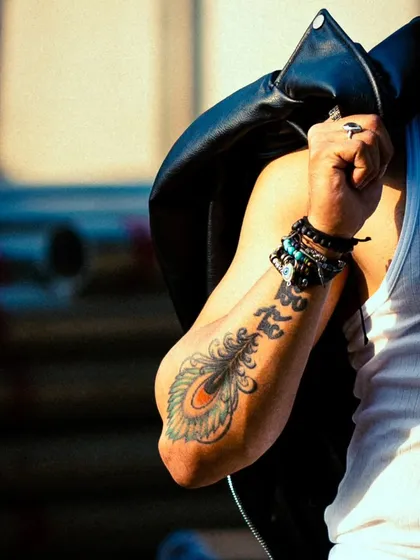A close-up detail shot focusing on the tattoo and accessories. These shots add depth and personality to a portfolio.