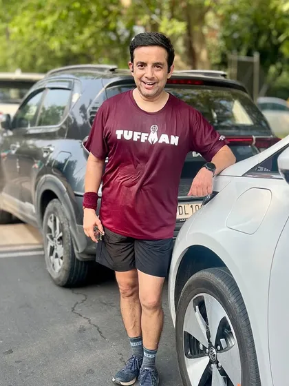 A member in a Tuffman shirt looking accomplished after his run. Seeing our members participate in various races is a huge motivation for the group.