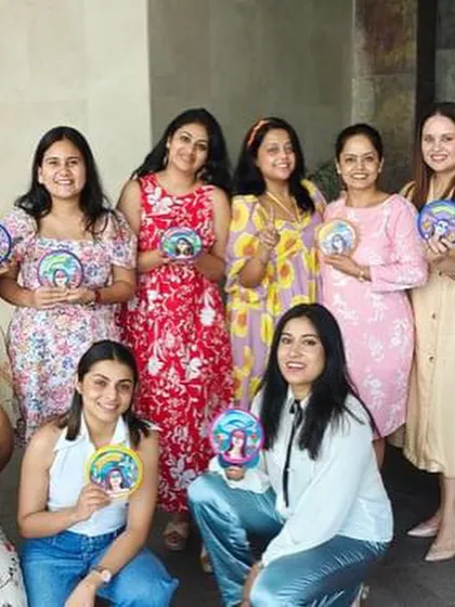 A group of happy women showing off their personalized mini plates, a special gift I created for their team.