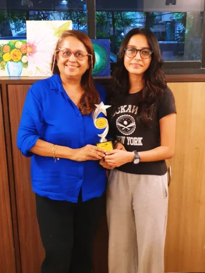 Here I am with my student Zaisha, who has been with me for so many years. This trophy is a symbol of her hard work and her brilliant score of 98 in the ICSE art exam.