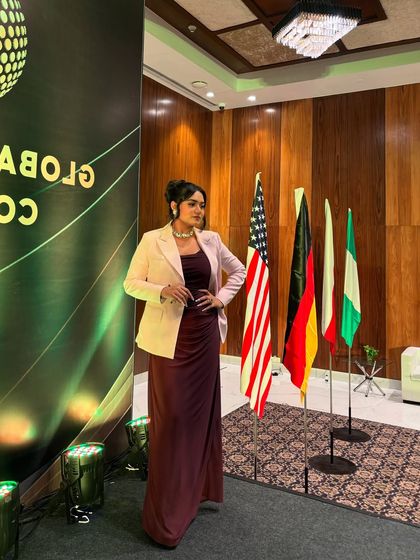 A full-length shot at the Global Investment Convention, showcasing my professional attire against the event's formal backdrop.