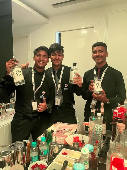 The team proudly holding up bottles of Zoya Gin. We love working with high-quality, local brands.