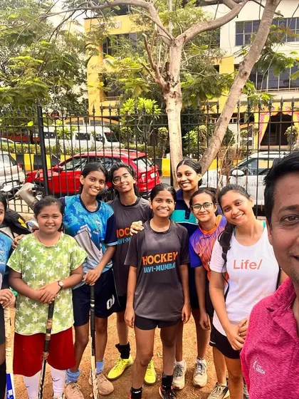 A happy selfie with the girls' team and a coach. We foster a positive and supportive relationship between our coaches and players.
