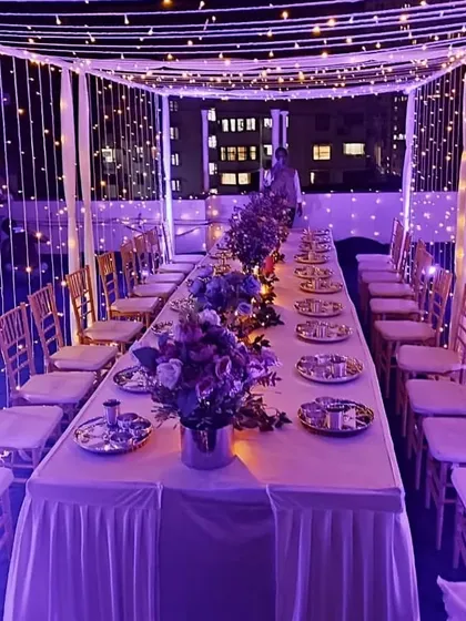 The same lavish dinner setup under a different light, showing how purple uplighting can change the mood to something more vibrant and celebratory.