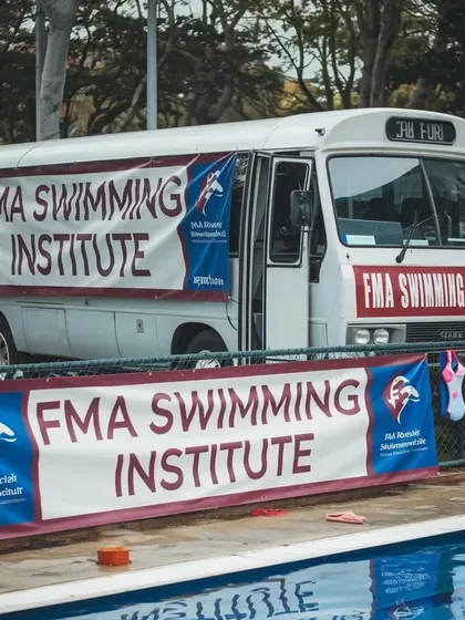 The FMA Institute bus, ready to transport our students. We provide convenient services to ensure our swimmers can get to their training sessions easily and safely.