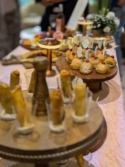 A lively shot of the catering table at the GAIA boutique launch. The focus is on our signature truffle cigar rolls and mini sliders, ready to be enjoyed by guests.