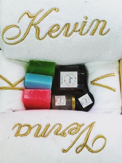 Another beautiful and luxurious couple's gift hamper for a bride and groom. The gold embroidery on the white towels adds a touch of class, paired with colorful handmade soaps and other bath essentials.